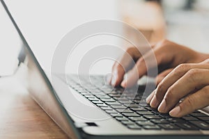 Closeup of male hands typing on the computer keyboard, businessman or student using laptop at home, online learning, internet mark