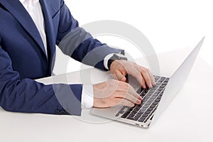 Closeup Male hands Typing on a Laptop on the table