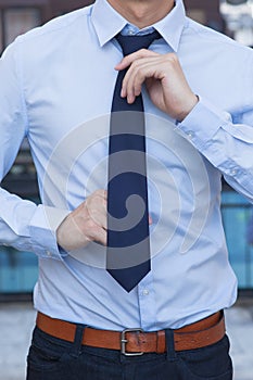 Closeup of Male office worker tying a tie