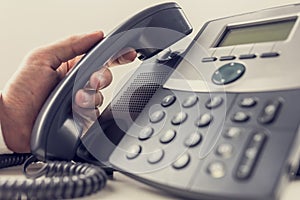 Closeup of male operator about to answer a phone call