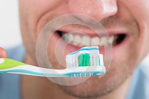 Closeup Of Man Brushing Teeth