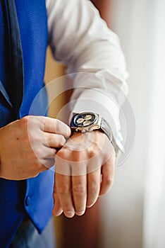 Closeup of man in casual wear look his watch