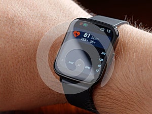 Closeup man checking health smart watch or smartwatch wearable technology sport smartwatch on fitness