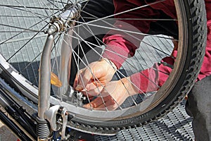 Closeup of a man, doing bicycle repairs and mainte