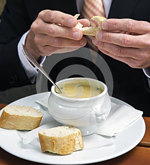 Closeup of man eating a bowl of soup