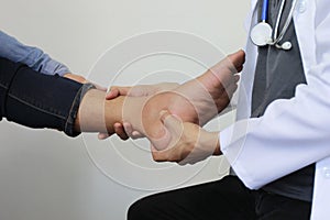 Closeup of Man feeling pain in her foot and doctor the traumatologist examines or treatment on white background, Healthy concept photo