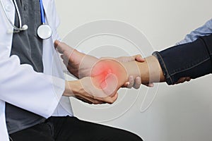 Closeup of Man feeling pain in her foot and doctor the traumatologist examines or treatment on white background, Healthy concept photo