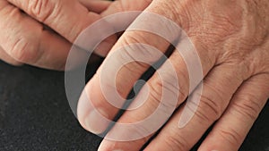 Closeup of man with finger tremor