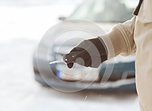 Closeup of man hand with car key outdoors