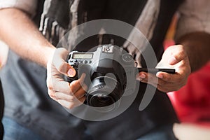 Closeup Of Man hand holding dslr camera and taking photo