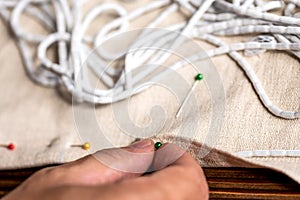 Closeup from man hand with sewing pins