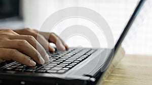 Closeup man hands typing on a computer keyboard, businessman or student using laptop at home, online learning, internet marketing,