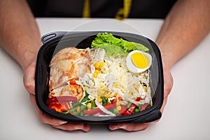 Closeup of a man holding a box full of protein rich foods for sports nutrition