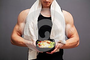 Closeup of a man holding a box full of protein rich foods for sports nutrition