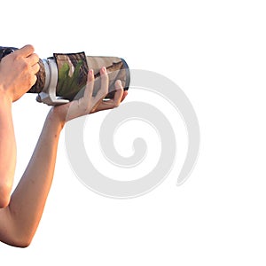 Closeup of man holding digital camera with lens zoom isolated on white background