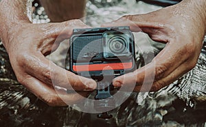 Closeup of a man holding a GoPro camera