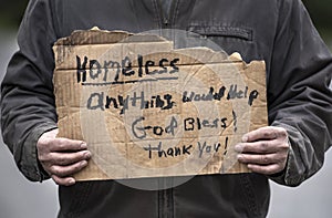 Closeup man holding Homeless handmade cardboard sign, dirty hands, unemployed, job