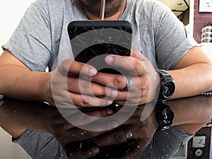 Closeup man holding smartphone hand