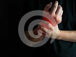 Closeup man holds he wrist hand injury, feeling pain. Health care and medical conept