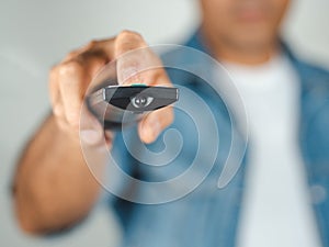 Closeup of a man pess the remote controller button on white background