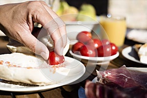Man preparing pa amb tomaquet, bread with tomato photo