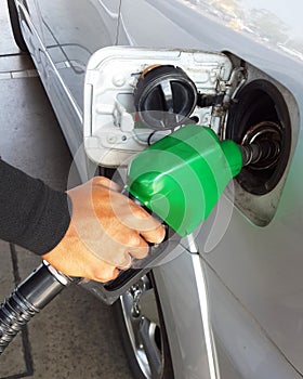 Closeup of man pumping gasoline fuel in car