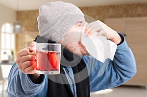 Closeup of man with rhinitis blowing his nose