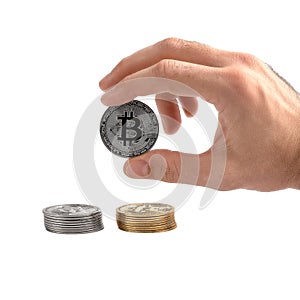 Closeup man`s hand holding silver Bitcoin, isolated on white background. Digital currency money trading with cryptocurrency, coin