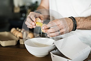 Closeup of man separating egg yolk