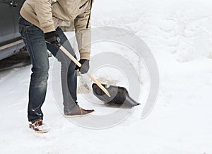 Closeup of man shoveling snow from driveway