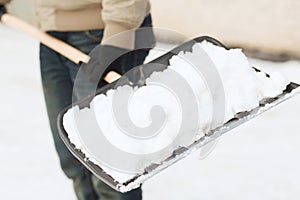 Closeup of man shoveling snow from driveway