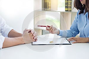 Closeup of a man Signing Contract or premarital agreement, filling petition form agreement of divorce in office at lawyer desk in