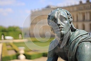 Closeup of man statue in the Gardens and Palace of Versailles, France