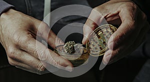 man about to grind a cannabis bud, web banner photo