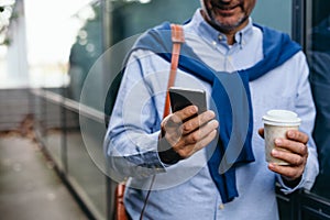 Closeup man using cellphone outdoor in the city