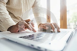 Closeup man using computer online