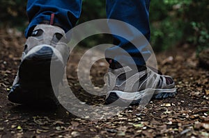 Closeup of man walking through a forest