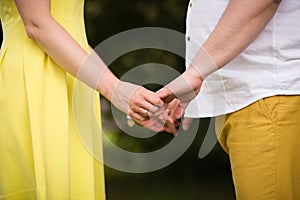 Closeup of man and woman holding hands. Couple in love