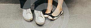 Closeup of man and woman legs in outdoor shoes together. Couple dating sitting together. Love and romance. Romantic dating.