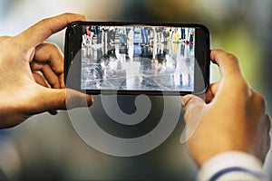 Closeup of man or woman taking a picture of the legs of a big group of people waiting to enter at their flight at the airport -