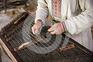 Closeup of a man's hands playing cimbalom in Pyrohovo museum of folk architecture in Kyiv, Ukraine. photo