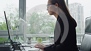 Closeup manager typing computer in office. Beautiful businesswoman ponder issue