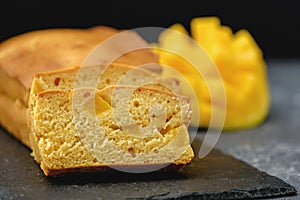 Closeup mango cake on black backround, homemade pound cake photo