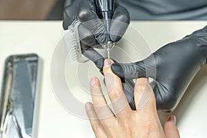 Closeup of manicurist hands and client on procedure