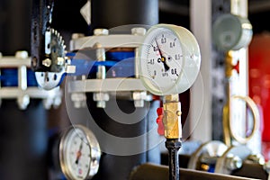 Closeup of manometer, measuring gas pressure. Pipes and valves a