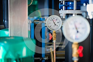 Closeup of manometer, measuring gas pressure. Pipes and valves a