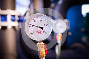 Closeup of manometer, measuring gas pressure. Pipes and valves a