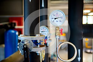 Closeup of manometer, measuring gas pressure. Pipes and valves a