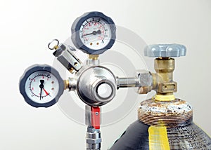 Closeup of manometer, measuring gas pressure. Pipes and valves at industrial plant.