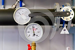 Closeup of manometer, measuring gas pressure. Pipes and valves at industrial plant. Pressure gauge, measuring instrument close up